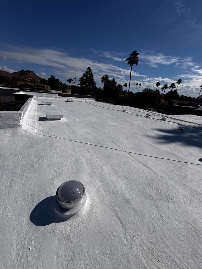 Finished Flat Coated Bright White Commercial Roof under Blue Sky