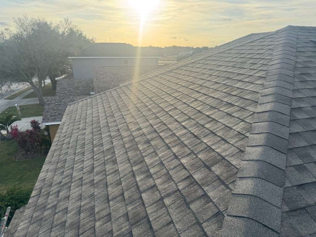 Clean charcoal black dimensional architectural asphalt shingle roof on a luxury South Florida home