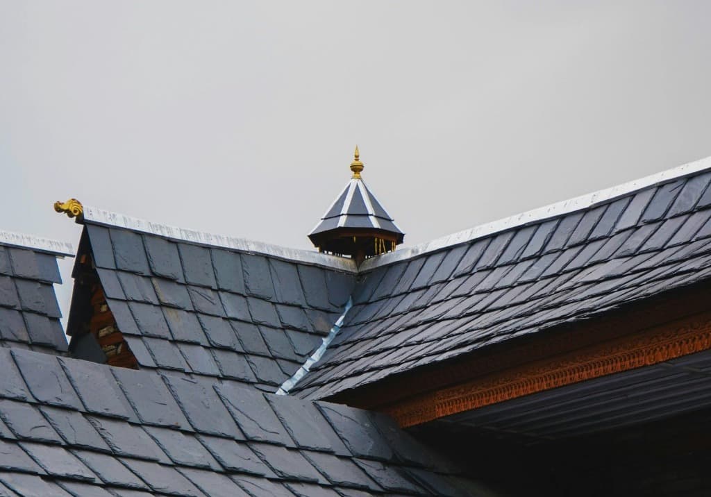 Close-up of a premium natural slate roof with custom copper flashings